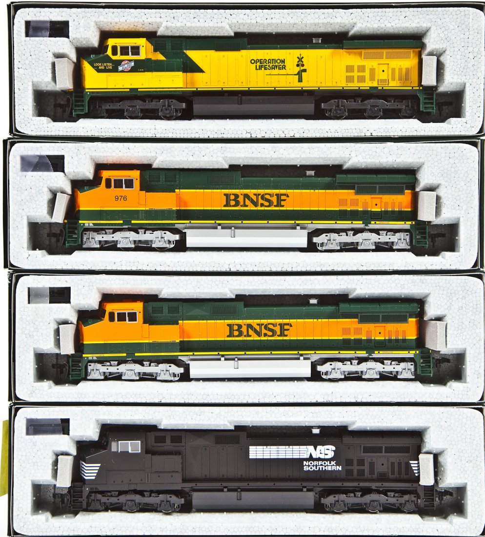 4 Kato C44-9W Locomotives: DESCRIPTION: Four Kato C44-9W locomotives including NS unnumbered, BNSF #976, CNW Operation Lifesaver unnumbered, and BNSF unnumbered. HO scale. CONDITION: Appear unused in original boxes.