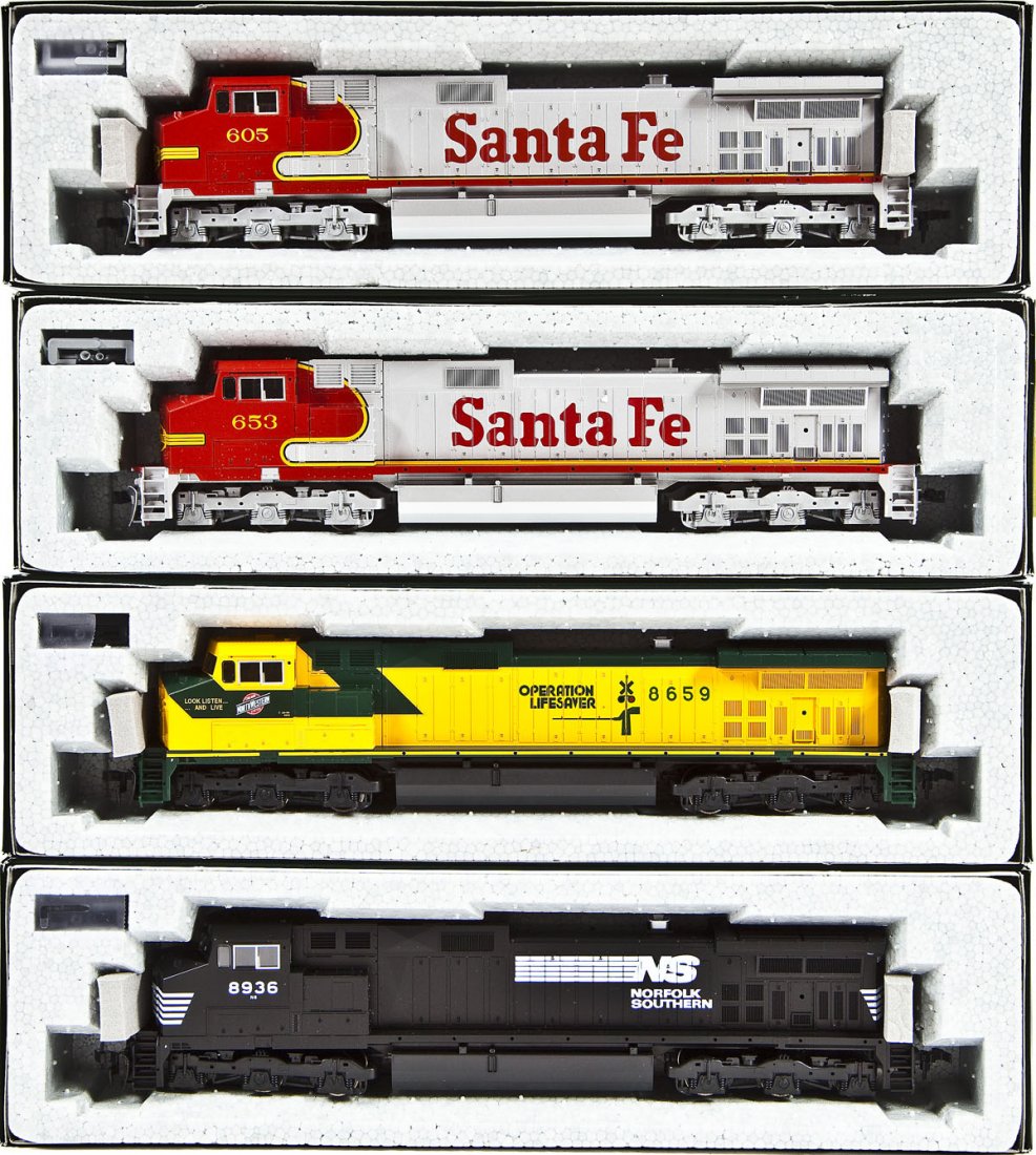 4 Kato C44-9W Locomotives: DESCRIPTION: Four Kato C44-9W locomotives including SF #653, CNW Operation Lifesaver #8659, NS #8936, and SF #605. HO scale. CONDITION: Appear unused in original boxes.