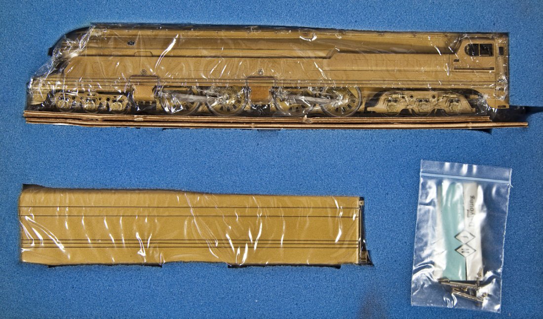 NJ Custom Brass PRR S-1 Duplex Streamline Loco: DESCRIPTION: NJ Custom Brass PRR Class S-1 Duplex Streamline brass locomotive and tender. Made by Daiyoung. HO scale. CONDITION: Appear unused in original box.