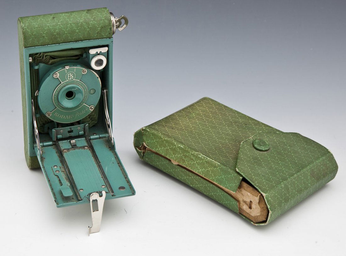 Green Kodak Petite Camera: DESCRIPTION: Kodak Petite camera. Special variant of Vest Pocket Model B. Green version with original green bellows. Autographic back. With matching green paper covered wood case. Circa 1929. MEASUREM