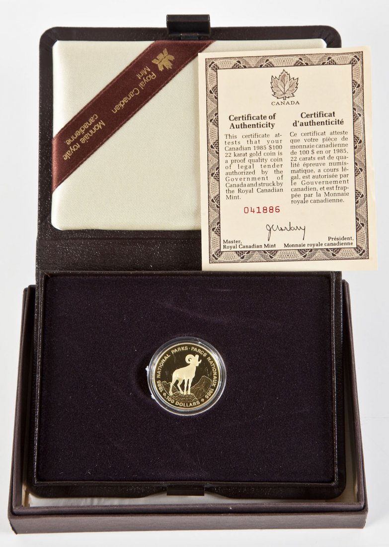1985 Canadian $100 Gold Proof Coin: DESCRIPTION: 1985 Canadian $100 22 karat gold proof coin issued by the Royal Canadian Mint. Obverse with Arnold Machin's effigy of Queen Elizabeth II. Reverse with Bighorn sheep designed by Hector Gre