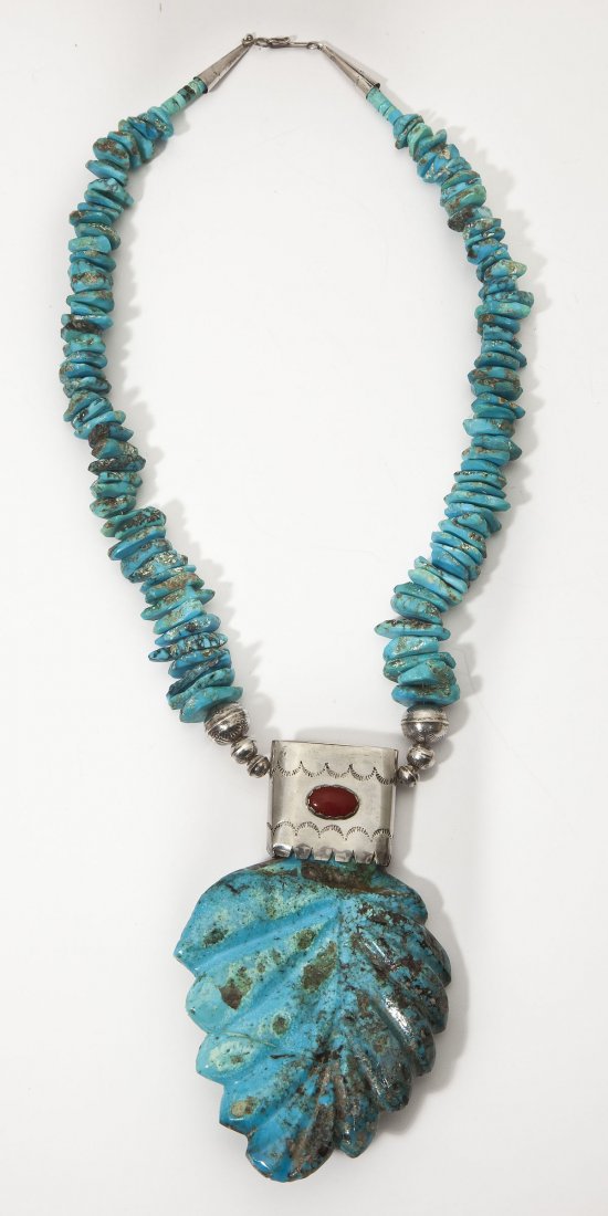 Large Zuni Turquoise Arrow Necklace W. Paquin: DESCRIPTION: Large Zuni necklace of asymmetrical turquoise pieces from which hangs a large turquoise carved in the form of an arrow in a silver frame with oval carnelian stone. Signed "W. Paquin". Inc