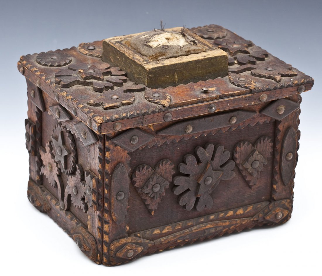 Large Pennsylvania Tramp Art Box with Pin Cushion: DESCRIPTION: Large tramp art sewing box with lift lid fitted with a square pin cushion. Overall applied carved decoration of rosettes, tulips, leaves, stars and hearts attached with tacks. Probably Pe