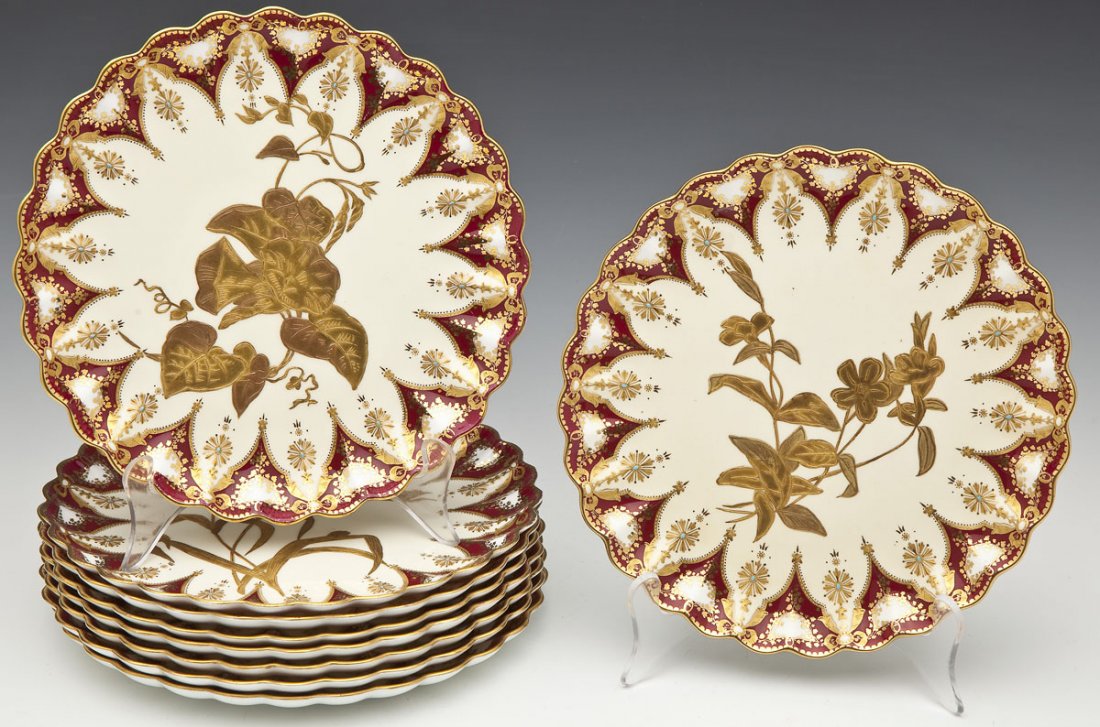 9 Copeland Spode Gilt & Enameled Dessert Plates: DESCRIPTION: Set of nine Copeland Spode dessert plates decorated to centers with various varieties of flowers in gilt on a cream ground. Surrounded by a burgundy and gilt swag border with enameling an