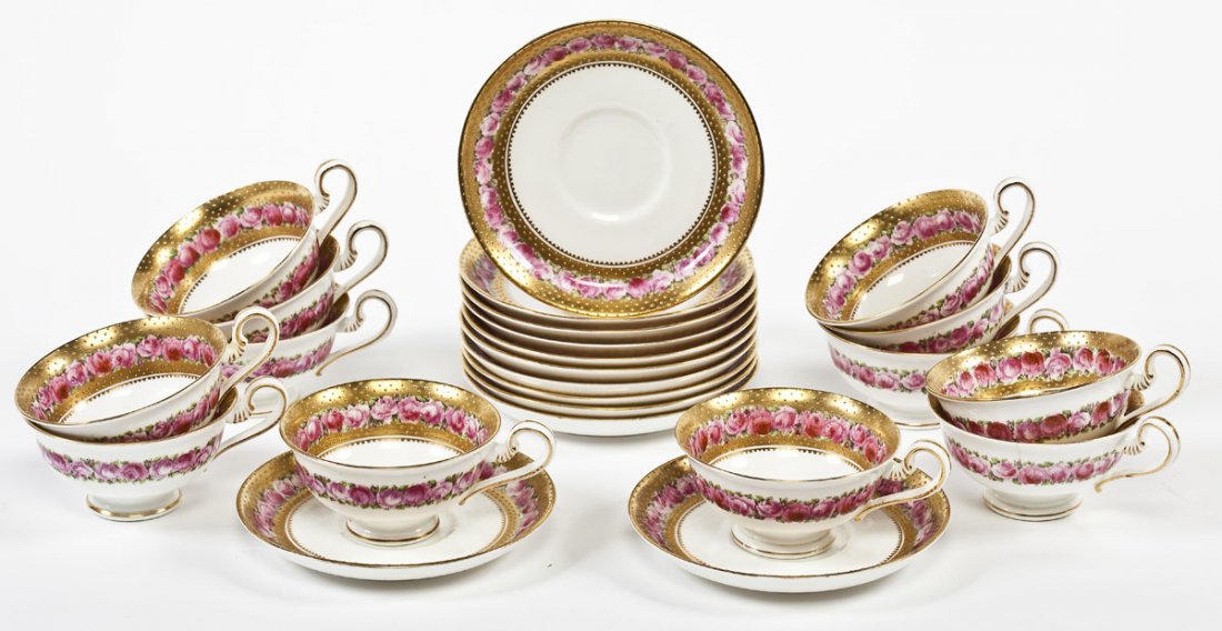 Set of 24 George Jones & Sons Cups & Saucers: DESCRIPTION: Set of twenty-four George Jones & Sons cups and saucers. Retailed by Ovington Brothers. Gold painted with rose motif. Interior of cups painted gold with swiss dots and border of roses. Ex