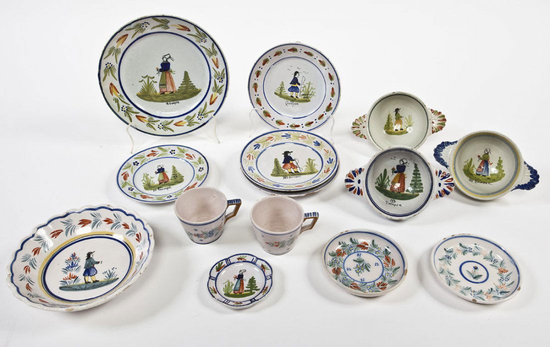 14 Pieces French Quimper Breton Dishes: DESCRIPTION: Fourteen pieces of French Quimper. Each piece decorated with either a Breton or Bretonne. Each is marked with "Quimper". Includes: three each of 7-1/4" plates, 7" handled bowls, two small
