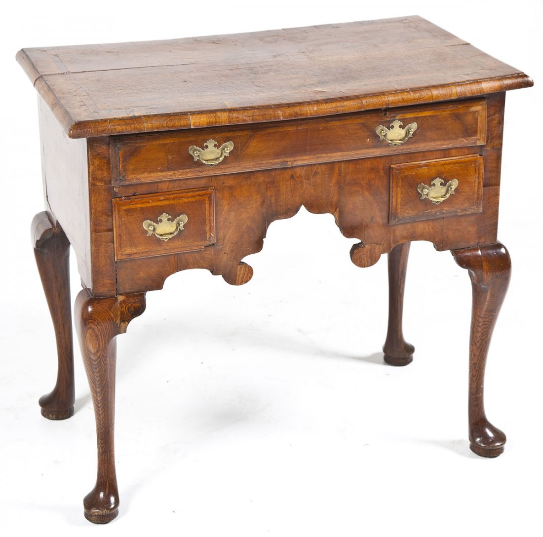 English Queen Anne Walnut Lowboy: DESCRIPTION: A period English Queen Anne lowboy or dressing table, circa 1740-60. The form consisting of four club foot legs resting on biscuits. The legs joining to the figured mahogany and yew venee