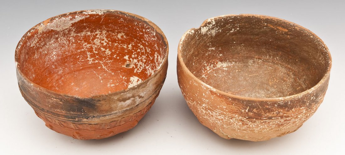 2 Hellenistic Megarian Bowls: DESCRIPTION: Two Hellenistic Megarian bowls. Includes: 1) Red-slipped bowl of hemispherical form. The base centered by a disk enclosing a rosette surrounded by acanthus leaves and flowers beneath a pe