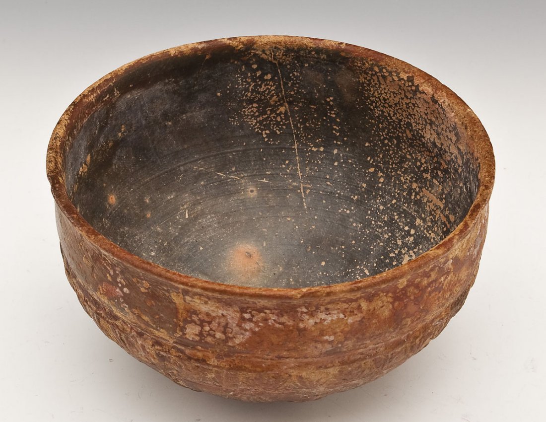Hellenistic Megarian Bowl: DESCRIPTION: Hellenistic Megarian bowl of hemispheric form. The base centered by a rosette surrounded by palm leaves and flowers beneath a petal form band. Circa 2nd century BC. MEASUREMENTS: 5-5/8" d