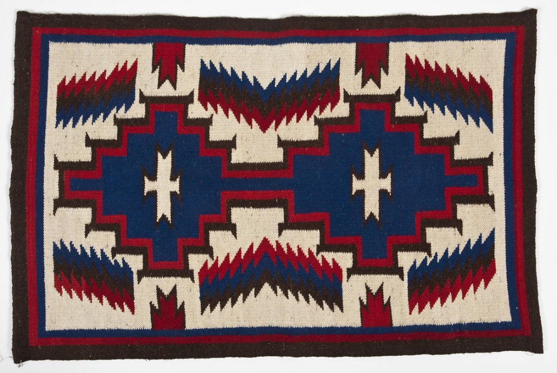 Circa 1970's Navajo Ganado Weaving: DESCRIPTION: Navajo Ganado cream, red, blue and brown weaving with the central double crosses associated with Ganado weavings. Circa 1970's. Verso with hanging loop along top and bottom edges. MEASURE