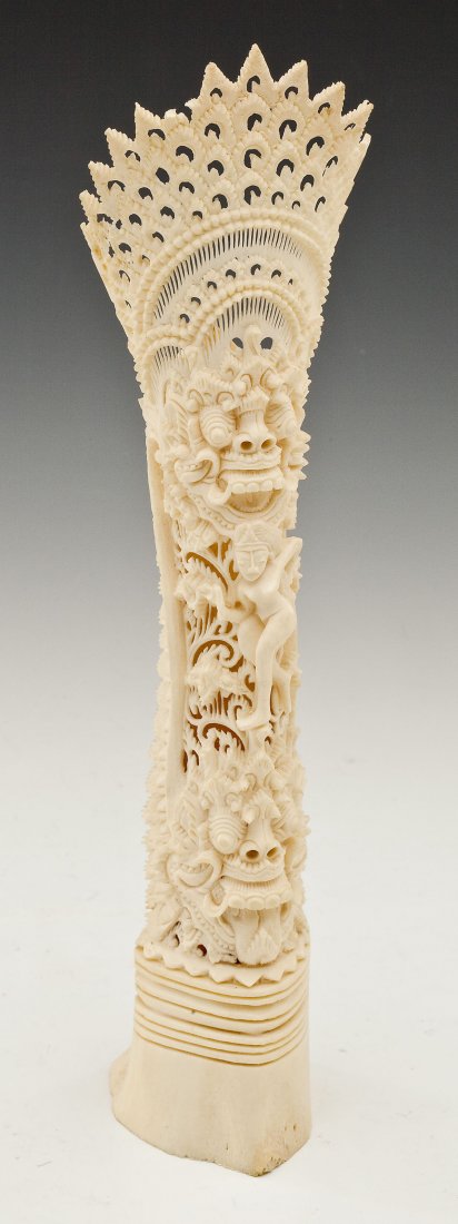 Indonesian Bone Carving of Deity: DESCRIPTION: Indonesian bone carved with deity on animal with reticulated peacock feathers. 20th century. MEASUREMENTS: 11" high. CONDITION: Small loss to peacock feathers at left rim.