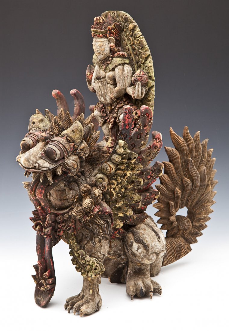 Hindu Carved & Polychrome Wood Figure of Durga: DESCRIPTION: A Hindu or Buddhist carved and polychrome wood figure of the goddess Durga riding a tiger. PROVENANCE: Purchased by the consignor in Hong Kong in 1983. MEASUREMENTS: 16" x 8" x 10". CONDI