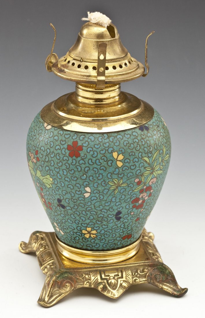 Japanese Cloisonne Porcelain Oil Lamp: DESCRIPTION: Japanese cloisonne porcelain oil lamp. Baluster form with overall floral decoration. Brass mounts. Venus burner. Marked under base "P.E.G.". Meiji period. MEASUREMENTS: 8" high overall. C