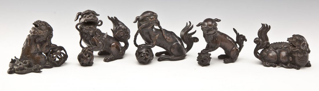 5 Small Chinese Bronze Foo Dogs: DESCRIPTION: Collection of five Chinese bronze foo dogs including one recumbent and four seated with balls. Circa late Qing Dynasty. PROVENANCE: From the estate of an Ohio collector. MEASUREMENTS: 2-3