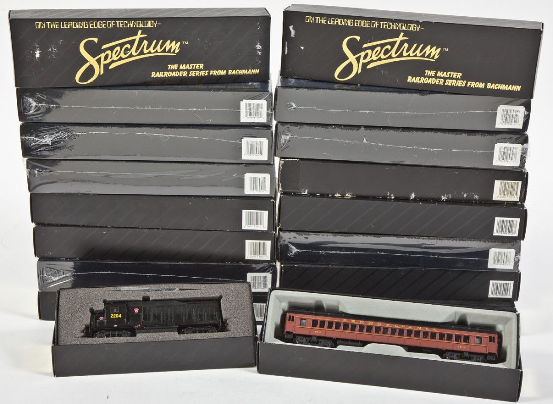 Bachmann Spectrum Locomotive & 18 Cars: DESCRIPTION: Eighteen Spectrum passenger cars and one PRR #2204 diesel locomotive. CONDITION: Appear unused in original boxes.