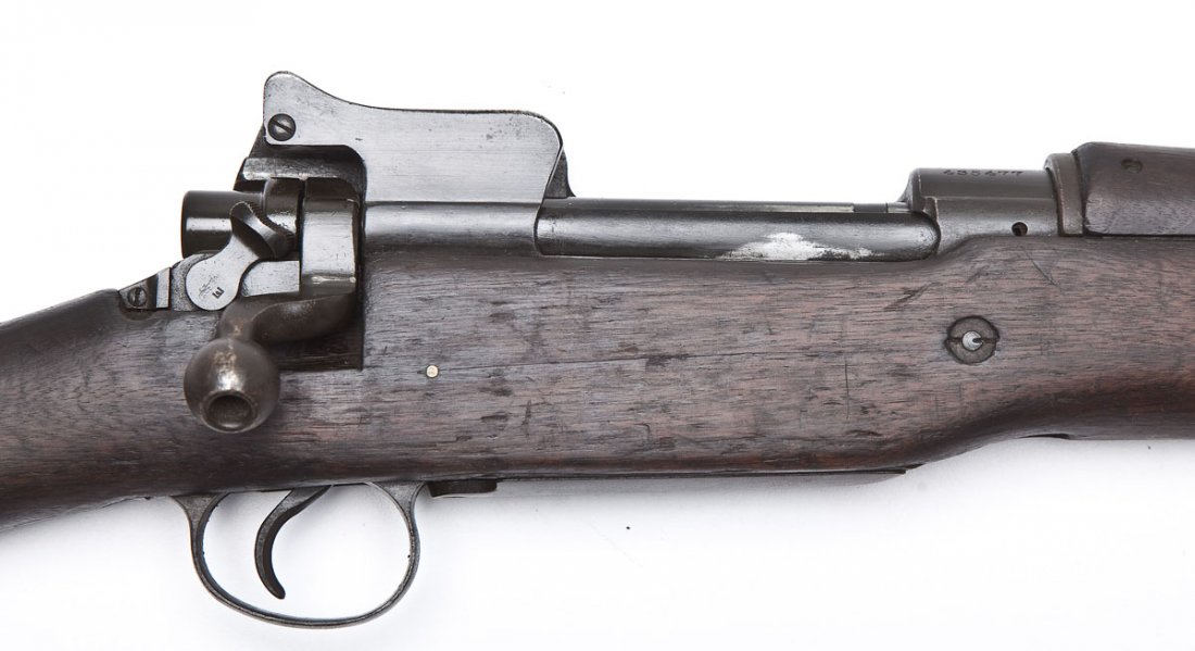 Winchester Model of 1917 Rifle - .30-06 Cal.: SERIAL #: 435477 DESIGN: Bolt action with internal magazine. 26" barrel. MATERIAL/FINISH COMPOSITION: Blued steel. Full length military wood stock. FEATURES: Semi hooded blade front sight. Rear apertu