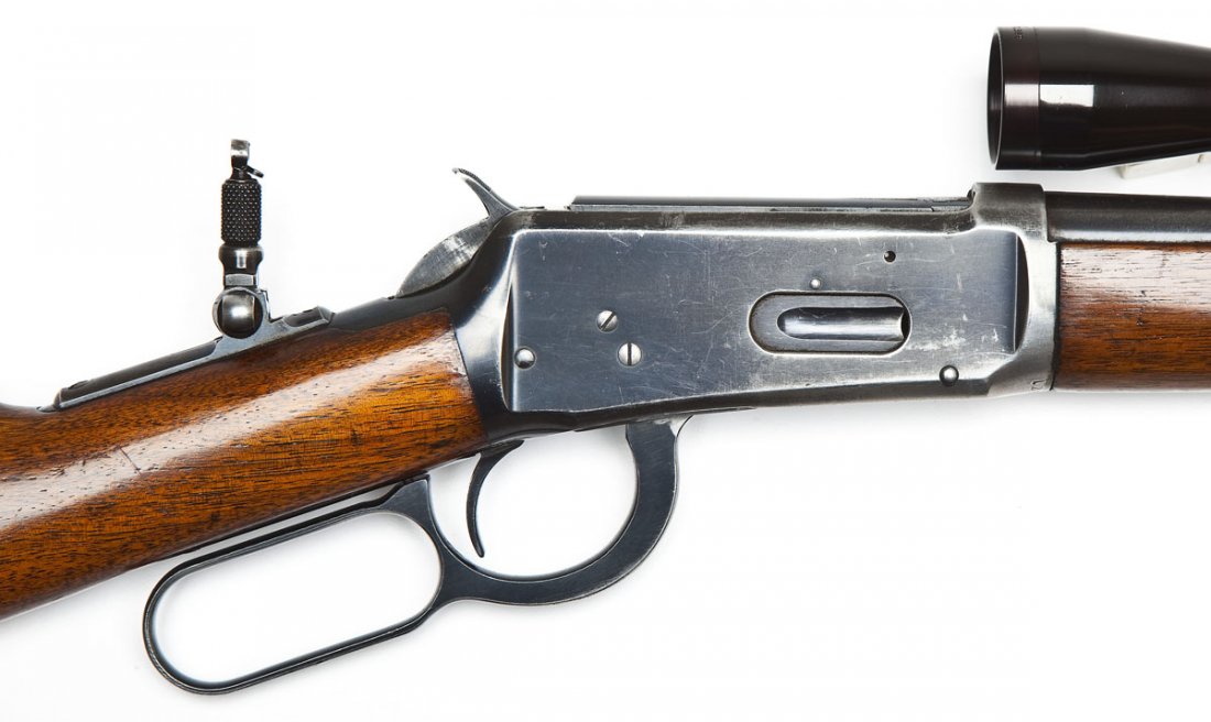 Winchester Pre-64 Model 94 Rifle - .30 W.C.F.: SERIAL #: 1293892 DESIGN: Lever action with full length tubular magazine. 20" round barrel. MATERIAL/FINISH COMPOSITION: Blued steel. Wood straight stock and forearm. FEATURES: Hooded blade front sigh