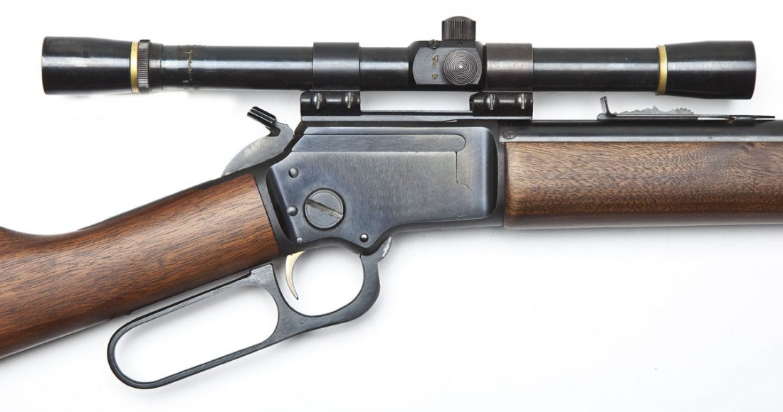 Marlin Golden 39A Mountie Rifle - .22 Cal.: SERIAL #: S 18254 DESIGN: Lever action with tubular magazine. 20" round barrel. MATERIAL/FINISH COMPOSITION: Blued steel. Wood straight stock and forearm. FEATURES: Hooded blade front sight. Step adju