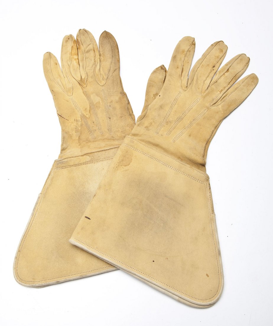 Indian Wars US Cavalry Gauntlet Gloves: DESCRIPTION: A pair of US Cavalry gauntlet gloves from the Indian Wars of the late 19th century, circa 1885. The gloves are of a thin light colored leather and are displayed in a black shadow box with