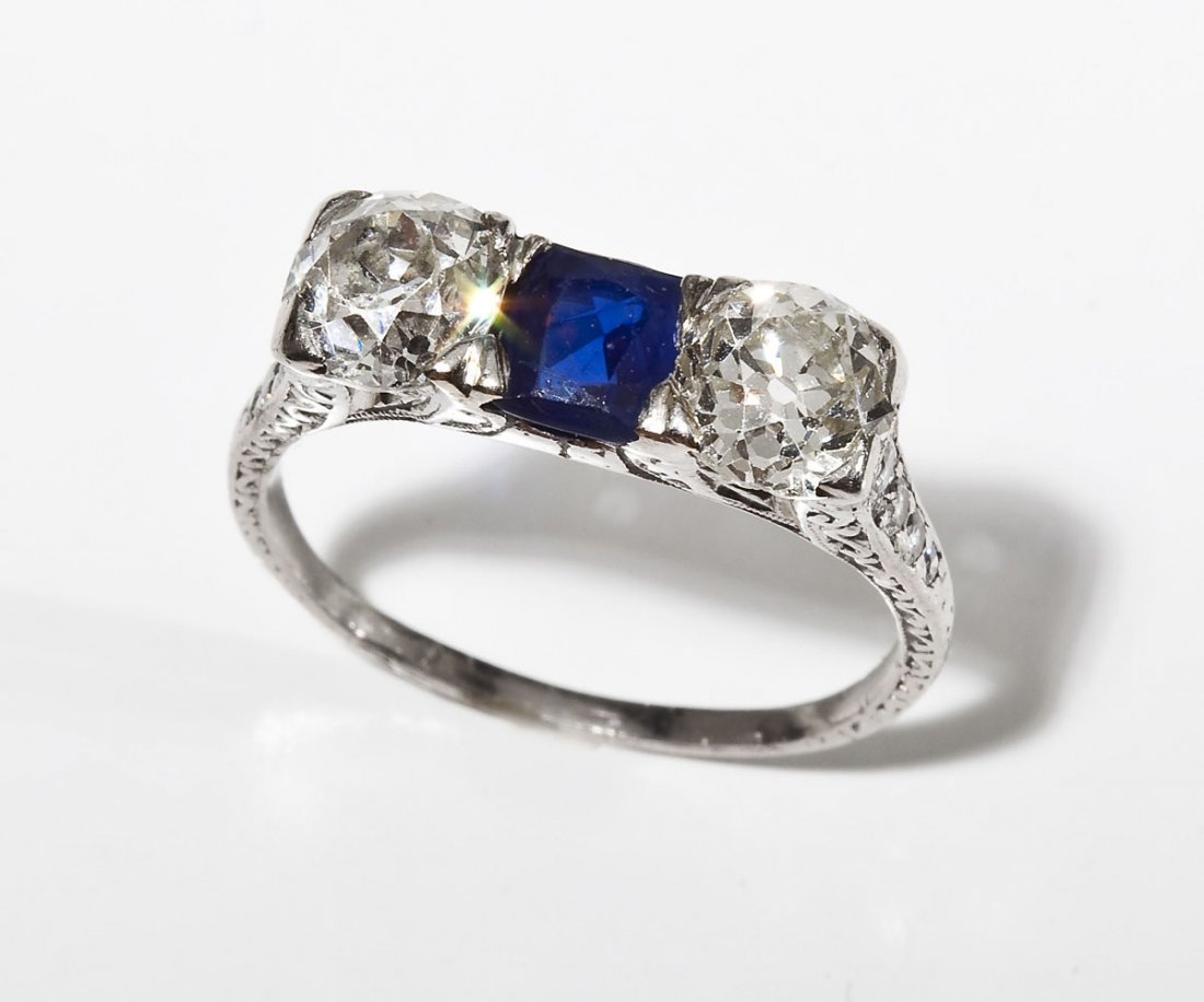 2.20 CTW Diamond & Sapphire Deco Ring: DESCRIPTION: Art Deco diamond and sapphire ring in platinum. Set with one approximately .90 carat natural sapphire and two Old European cut diamonds of .97 and .93 carat. Clarity VS1-2, color H-J. Sha