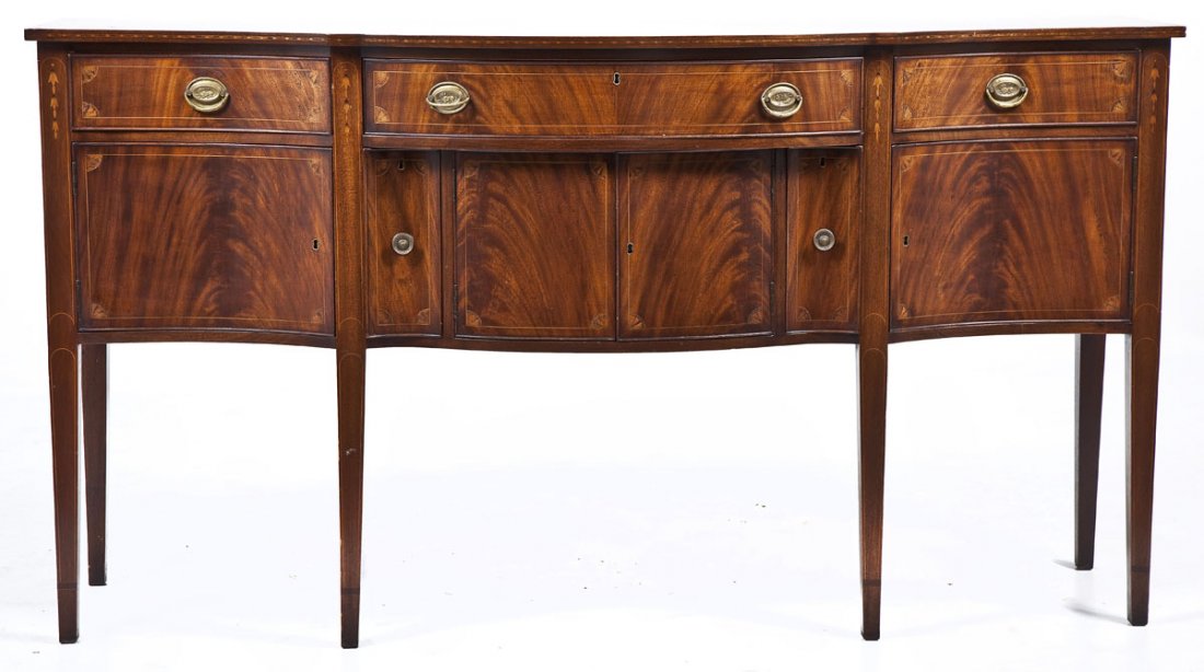 Harold Sack Reproduction Hepplewhite Sideboard: DESCRIPTION: Mahogany and mixed woods reproduction Hepplewhite sideboard with the label of "H. Sacks & Sons." The form consisting of finely inlaid (bell flowers and stringing) legs rising to join the 