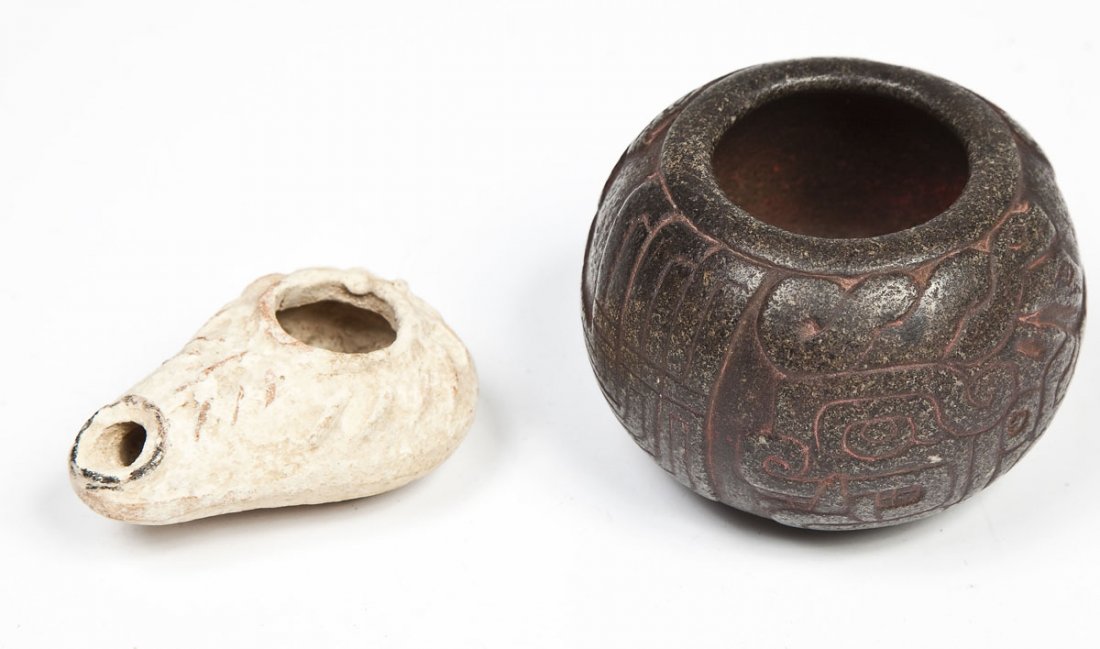 Peruvian Chavin Stone Pot & Ancient Oil Lamp: DESCRIPTION: Peruvian Chavin basalt stone pot carved with creatures, possibly pre-Columbian, with remnants of red pigment. Together with an ancient Middle Eastern pottery oil lamp. MEASUREMENTS: Pot 3