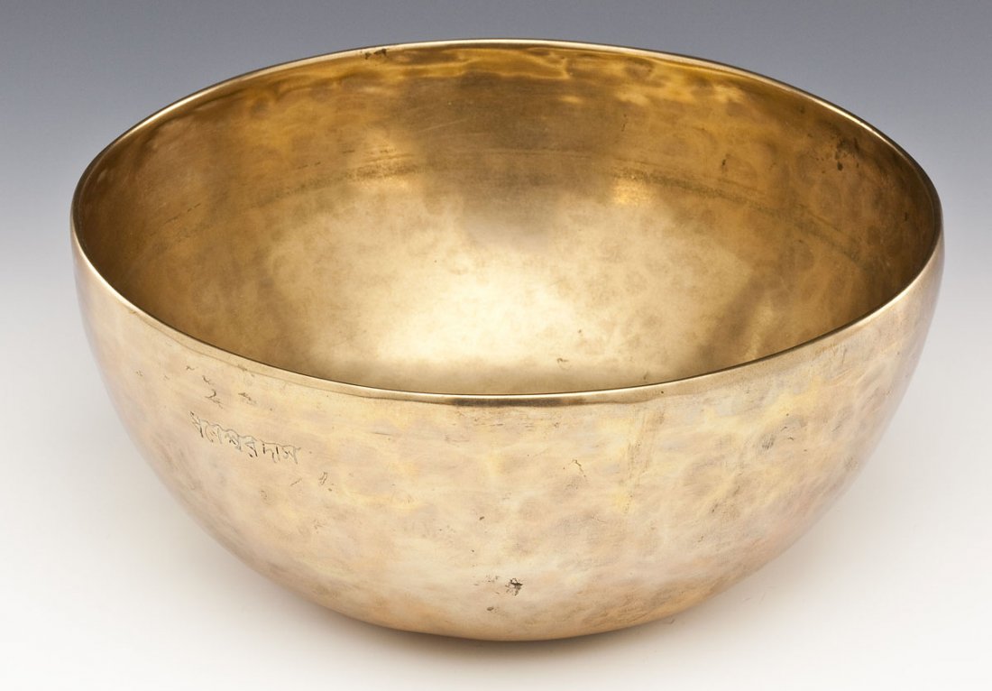 Brass Tibetan Singing Bowl: DESCRIPTION: Brass Tibetan singing bowl. Engraved in Tibetan script. MEASUREMENTS: 9-7/8" diameter x 4-3/8" high. CONDITION: Wear to interior from use. Some scratches and small dents to exterior. Miss