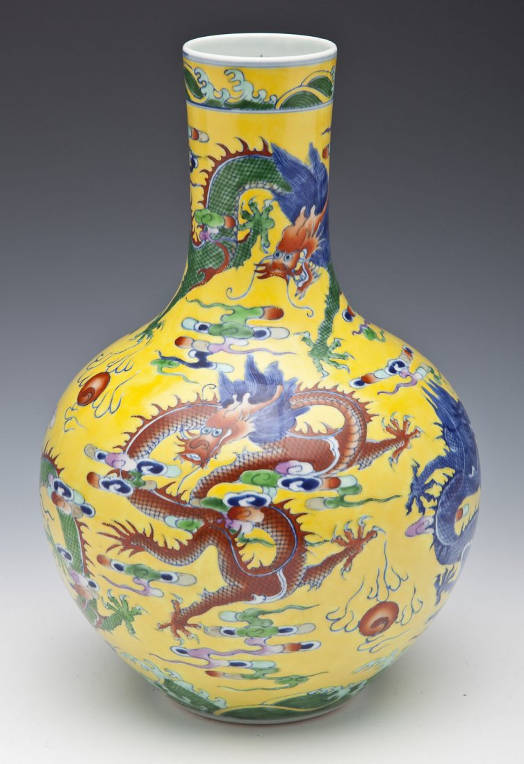 Chinese Yongzheng Style Dragon Vase: DESCRIPTION: Chinese vase decorated overall with polychrome enameled dragons with flaming pearls amongst clouds on a yellow ground. Yongzheng six character mark under base, but 20th century. MEASUREME