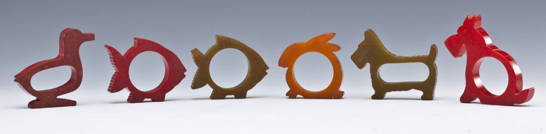 6 Bakelite Figural Napkin Rings: DESCRIPTION: Six Bakelite figural napkin rings. Includes two fish, one duck, one rabbit, one sitting Scottie dog and one standing Scottie dog. MEASUREMENTS: 2-1/4" to 3". CONDITION: Minor overall wear