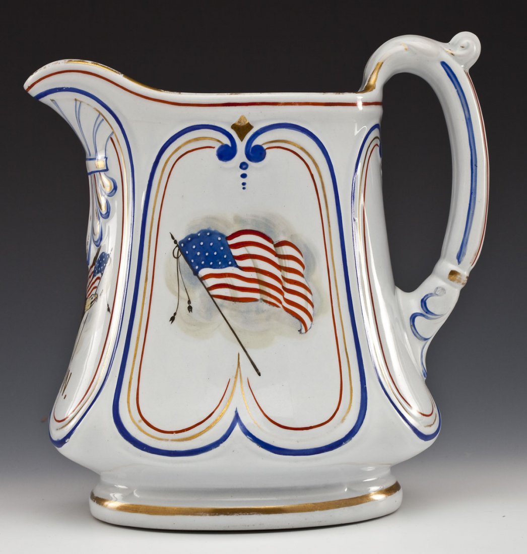 Patriotic Civil War Union Ironstone Pitcher: DESCRIPTION: Ironstone pitcher having paneled sides decorated with hand painted flags flanking an eagle with flag in beak with red, blue and gilt trim. Marked "Union" in gilt under eagle. MEASUREMENTS