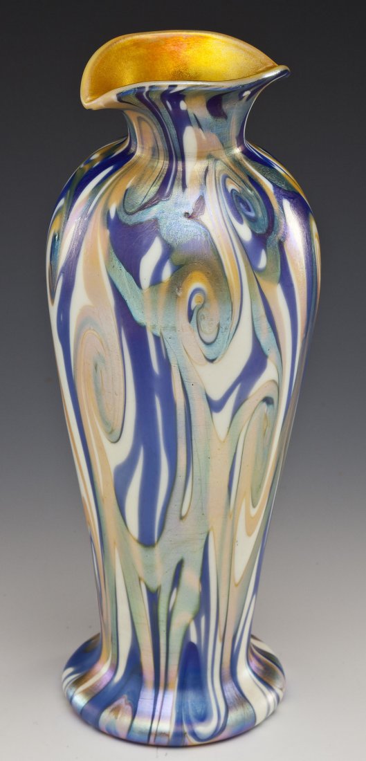 Attrib. to Durand King Tut Art Glass Vase: DESCRIPTION: Art glass vase attributed to Durand in the King Tut pattern. Blue and gold iridescent swirls on a cream ground with iridescent gold interior. Flared and pinched mouth. Cut and polished po