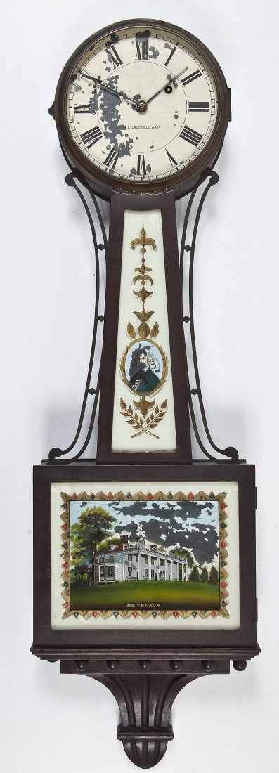 J.E. Caldwell Mt. Vernon Banjo Clock: DESCRIPTION: Banjo clock retailed by J.E. Caldwell & Co. Mahogany case. Painted metal dial with Roman numerals marked "J.E. Caldwell & Co." Glass tablets reverse painted with portrait of George Washin