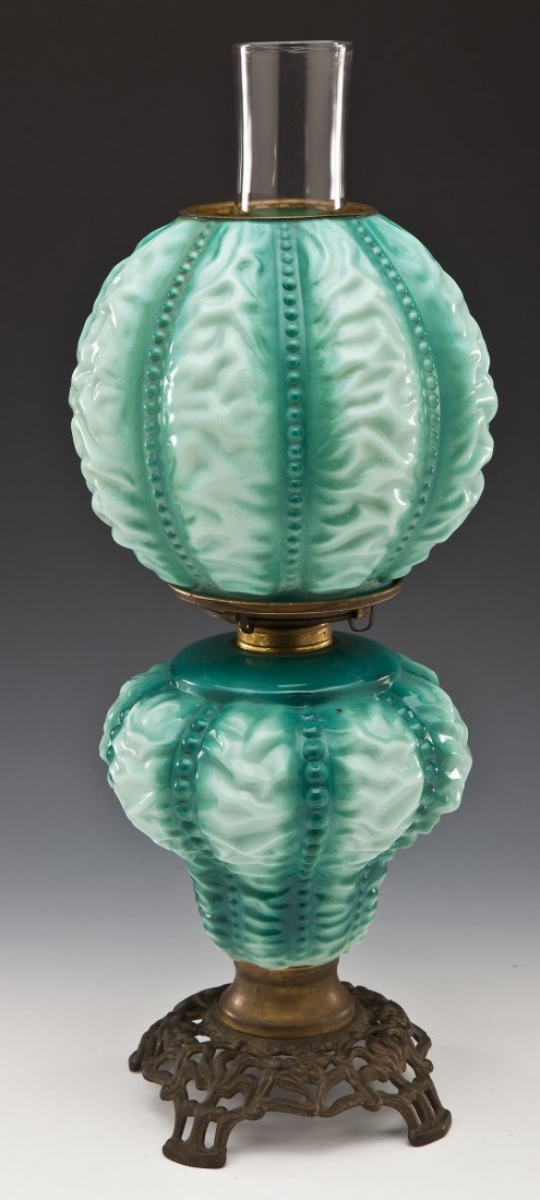 Beaded Drape Gone with the Wind Lamp: DESCRIPTION: Green Gone with the Wind lamp in the Beaded Drape pattern. Brass burner and scrolled and reticulated base. 19th century. MEASUREMENTS: 17-1/4" high wihthout chimney. CONDITION: Patina to 