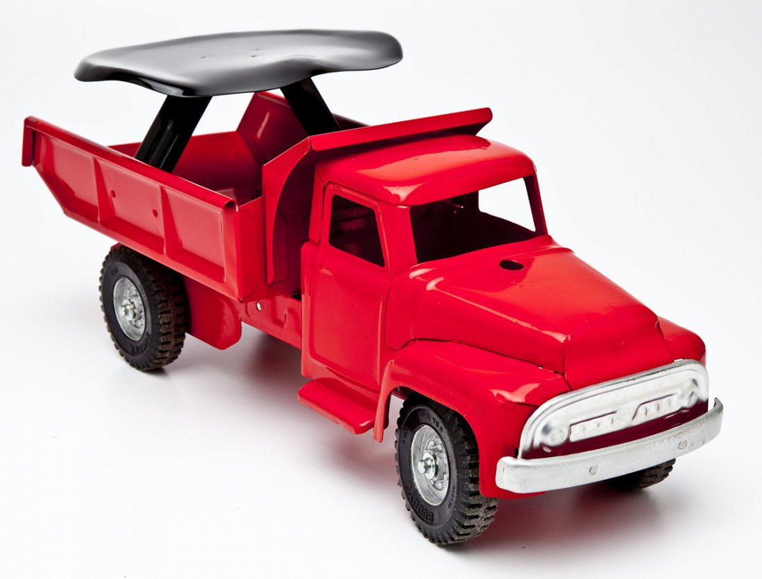 Buddy L Dump Truck Riding Toy: DESCRIPTION: Buddy L dump truck riding toy. MEASUREMENTS: 20". CONDITION: Restored. Missing steering wheel.