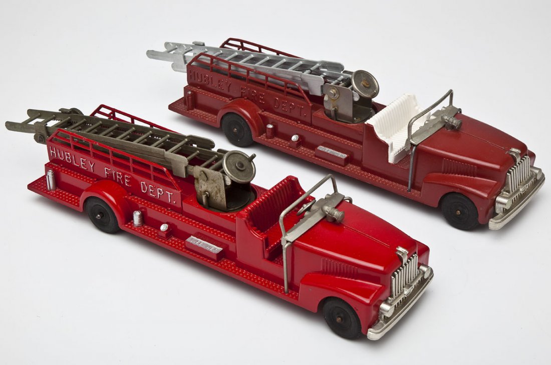 2 Hubley Kiddie Toy Ladder Trucks: DESCRIPTION: Two Hubley Fire Department cast metal kiddie toy ladder trucks #520. MEASUREMENTS: Each 18". CONDITION: Both restored.