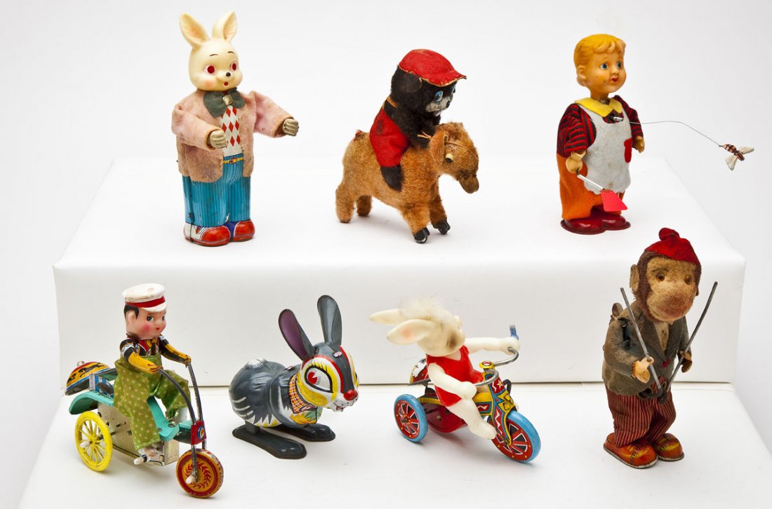 7 Wind-Up Toys: DESCRIPTION: Seven wind-up toys including stand-up bunny, bunny on tricycle with bell, hopping bunny, boy on tricycle, bear riding donkey, monkey with sticks and boy with flyswatter. MEASUREMENTS: Eac