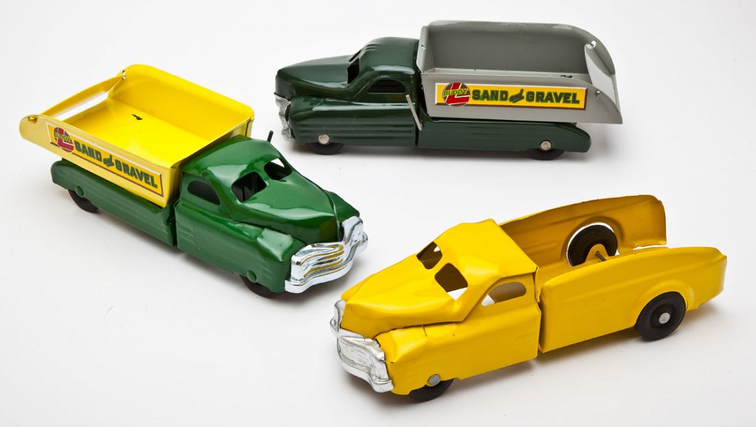 3 Buddy L Pressed Steel Trucks: DESCRIPTION: Three Buddy L pressed steel trucks including tow truck, and two sand and gravel trucks. MEASUREMENTS: Each 12-13". CONDITION: All restored. Tow truck missing tow.