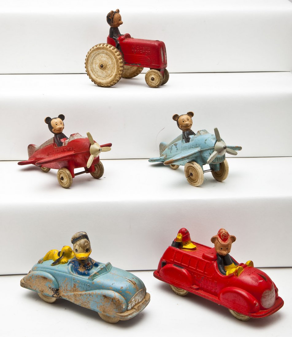 5 Rubber Disney Toys: DESCRIPTION: Five rubber Disney toys including two Mickey's Air Mail, Mickey Mouse Fire Department, Mickey's Tractor, and Donald Duck with Pluto convertible. MEASUREMENTS: Each 5-6-1/2". CONDITION: Al