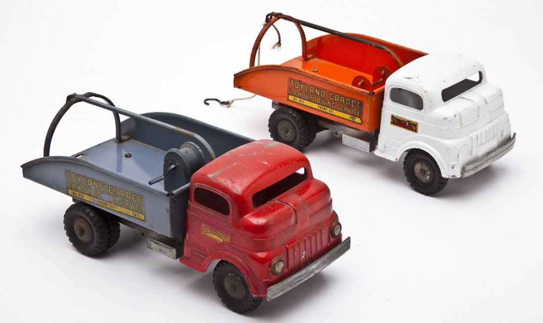 2 Structo Tow Trucks: DESCRIPTION: Two Structo Toys Toyland Garage tow trucks. MEASUREMENTS: Each 12". CONDITION: Original condition, missing parts.