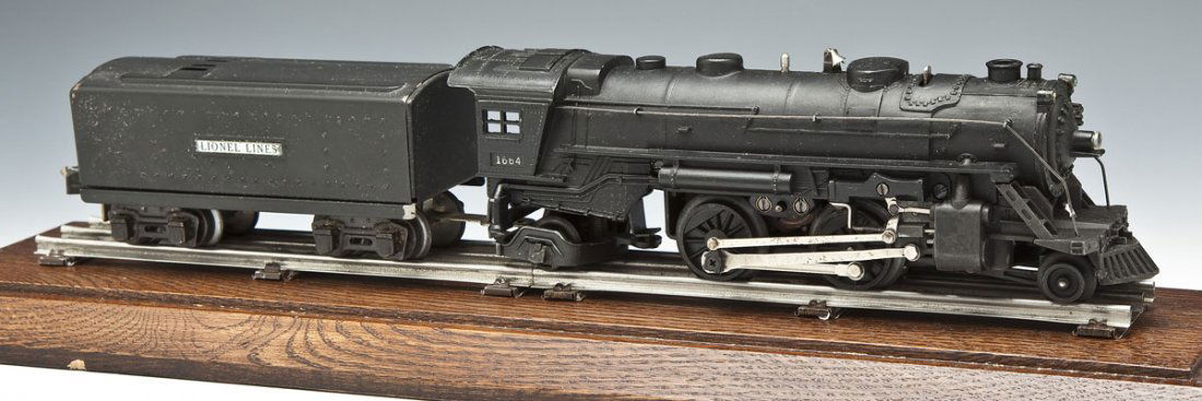 Lionel Prewar O Gauge 1664 Locomotive & Tender: DESCRIPTION: Lionel prewar #1664 locomotive and #2689T Lionel Lines tender. Housed in custom wood and plexiglass display case. MEASUREMENTS: O gauge. CONDITION: Very good to excellent.