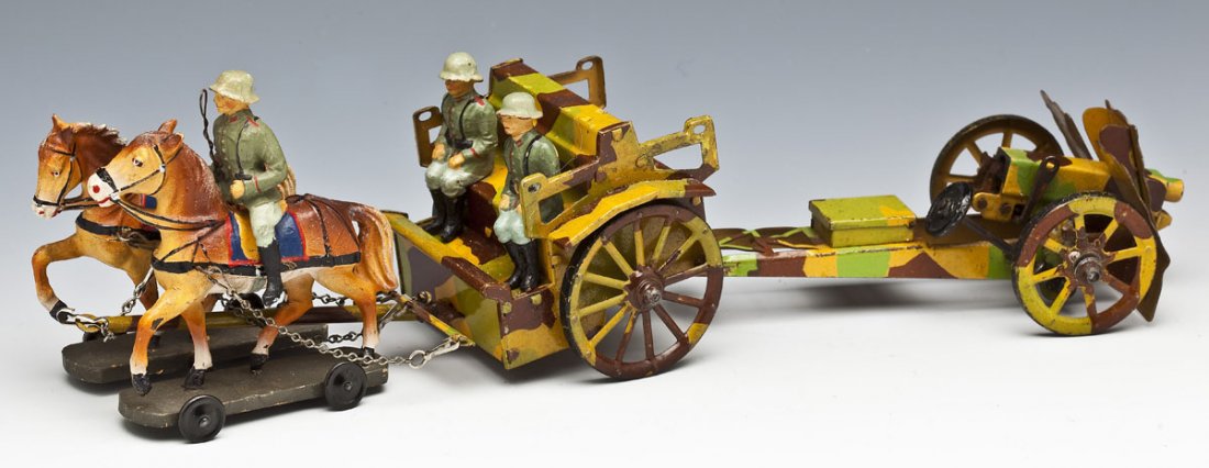 Hausser-Elastolin Horse Drawn Heavy Howitzer: DESCRIPTION: Hausser-Elastolin Horse-Drawn Heavy Howitzer, 7.0 cm scale. Limber and cannon are tinplate, toy soldier drivers and horses are composition. Very nice mid-1930's mimickry paintjob. Made in