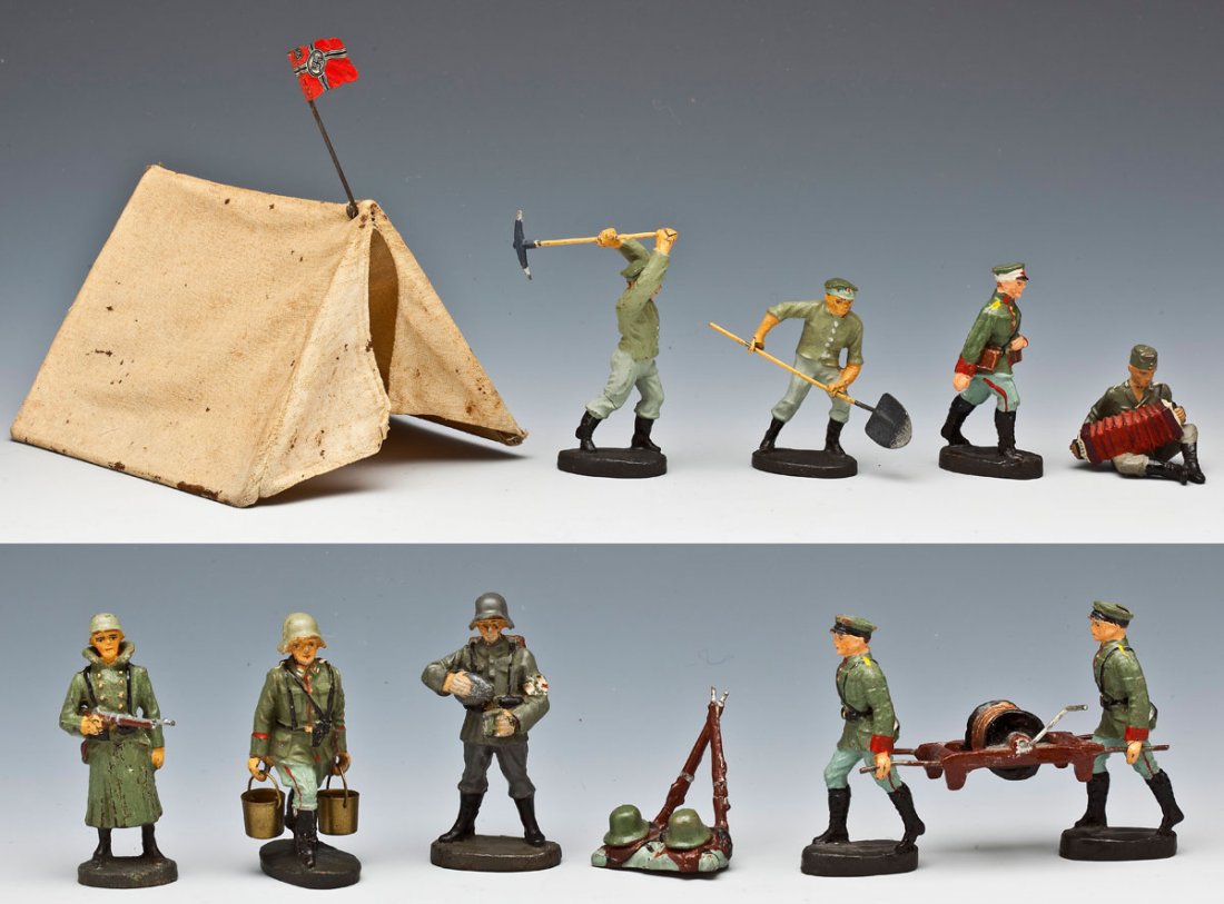 12 Elastolin & Lineol German Soldiers & Access: DESCRIPTION: Elastolin and Lineol group of eleven German Composition camp life toy soldiers and accessories plus one cloth tent with flag. Tent has wire frame with metal flag. Soldiers include rare El