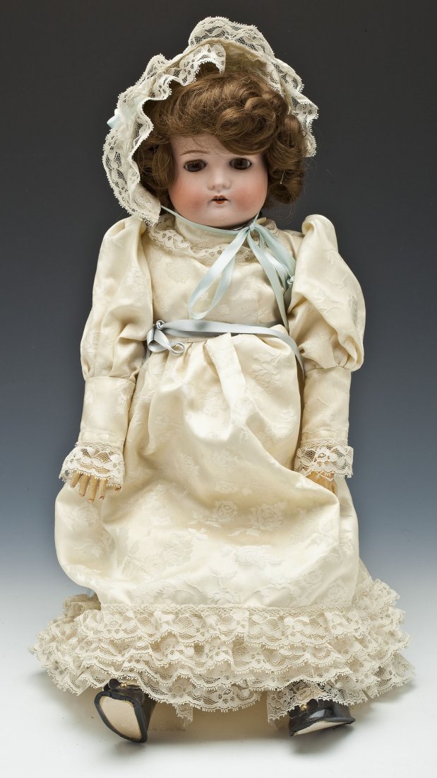 Dressel, Cuno & Otto Bisque Head Doll 1912-4: DESCRIPTION: Dressel, Cuno & Otto bisque socket head doll with brown sleep eyes, brown replaced wig, open mouth with four teeth, and jointed composition body. Back of head marked with star mark and "M