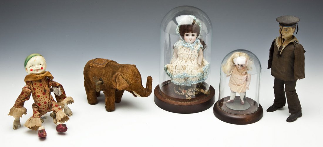 3 Antique Wind-Ups Toys & 2 Miniature Bisque Dolls: DESCRIPTION: Grouping of antique toys. Includes: 1) Mohair covered elephant wind-up. 6" long. Wear to mohair. Not working. 2) Japanese Otani tin, celluloid and cloth somersaulting clown. Includes Schu