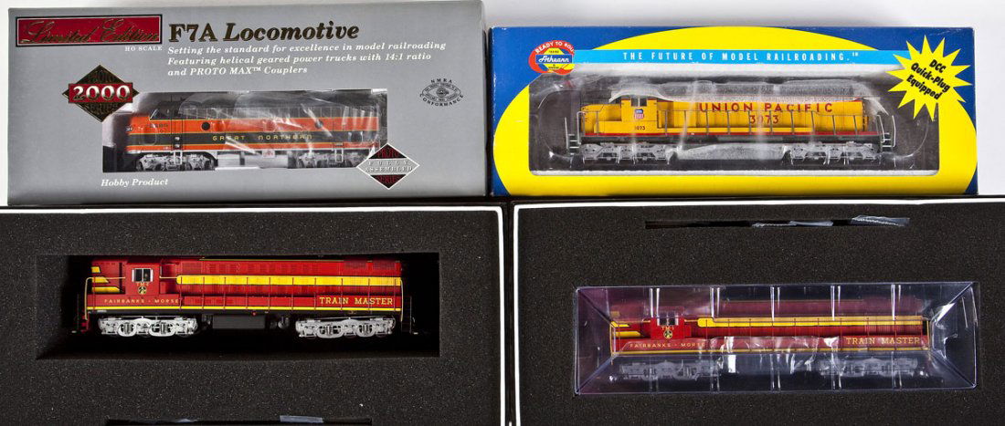 4 Locomotives incl Athearn, Proto 2000 & Atlas: DESCRIPTION: Four diesel locomotives. Including: Athearn UP #3073, Proto 2000 Series GN #268-A, and Atlas Fairbanks-Morse Road #TM-1 and #TM-2. CONDITION: Appear unused in original boxes.