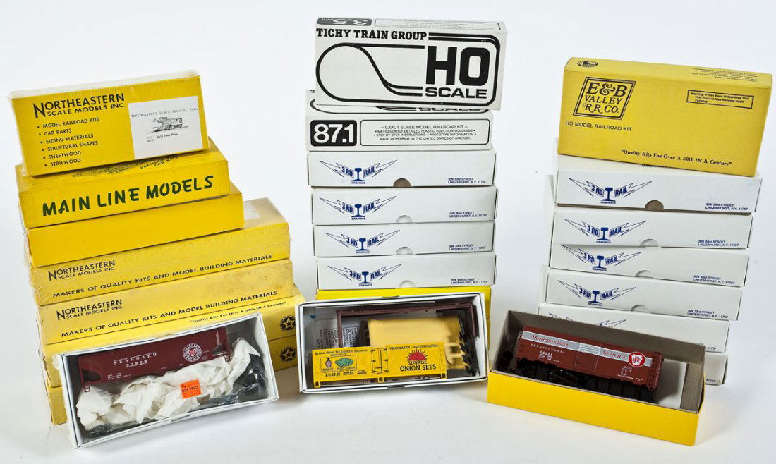 24 Car Kits incl Walthers & Tichy Train Group: DESCRIPTION: Twenty-four car kits. Including: Third Rail Graphics, Northeastern Scale Models, Mainline Models, Walthers, and Tichy Train Group. CONDITION: Appear unused in original boxes.