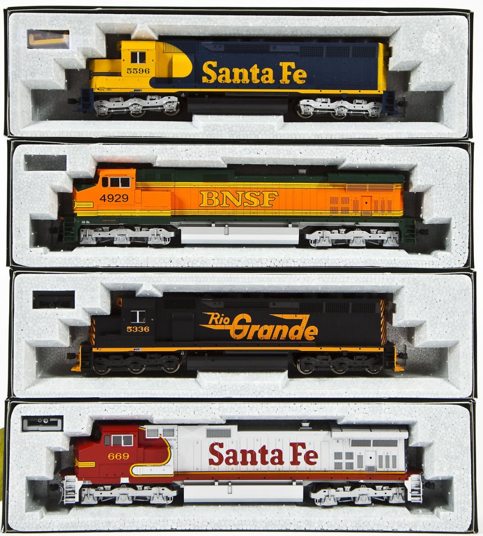 4 Kato Diesel Locomotives: DESCRIPTION: Four Kato locomotives including SF #669, NSF #4929, RG #5336, and SF #5596. HO scale. CONDITION: Appear unused in original boxes.