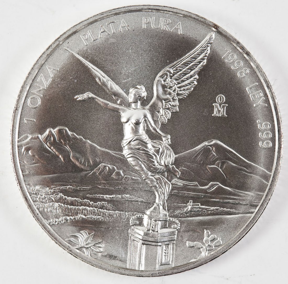 1998 Mexican 1 Oz Silver Libertad: DESCRIPTION: 1998 Mexican one ounce .999 silver libertad. Obverse with winged statue of Victoria, goddess of victory, on the Mexican Independence Victory Column. Reverse with Mexican coat of arms. The