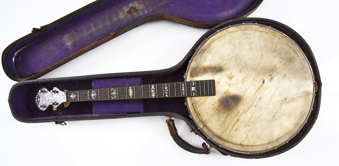 Rettburg & Lange Brass Band Orpheum Banjo: DESCRIPTION: Brass Band Orpheum tenor banjo by Rettburg & Lange. Mother of pearl inlaid fretboard and headstock. Headstock also inlaid "Brass Band Orpheum". Inlaid pot stamped "Patent 724833" with tag