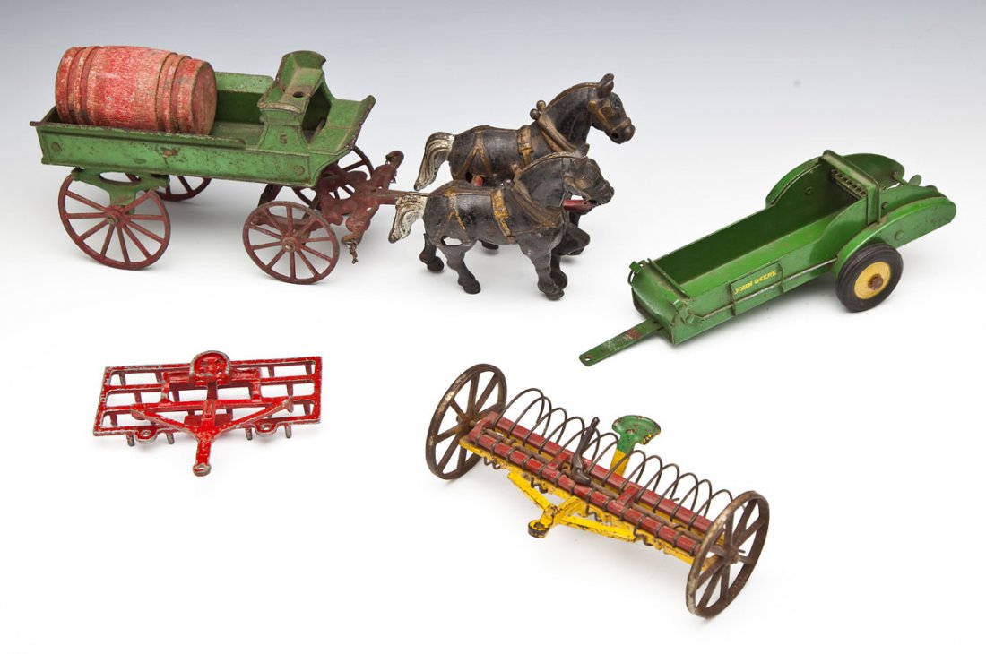 4 Cast Iron and Sheet Metal Farm Toys: DESCRIPTION: Four cast iron and sheet metal farm toys. Includes: 1) John Deere sheet metal spreader. 10" x 3-1/2" x 3" high. 2) Two horse and wagon toy with wooden barrel. 14-1/2" x 4-1/2" x 5" high.